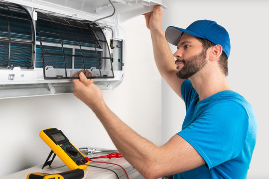 Certified AC repair technician servicing a split AC unit in Delhi NCR — EZAC Service